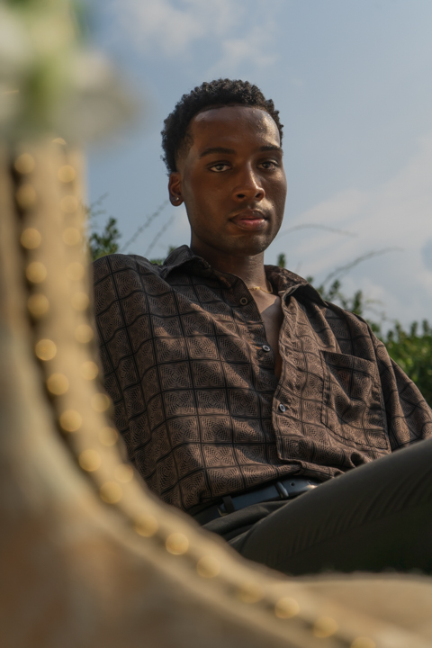 Headshot of well-dressed man lounging on a fancy chair