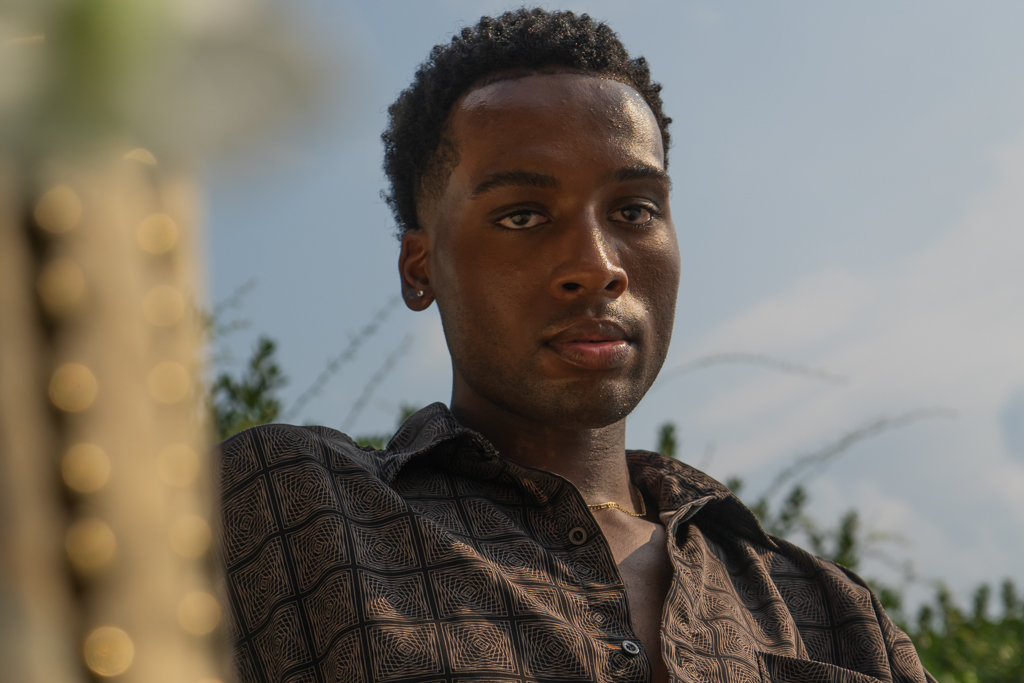 Headshot of well-dressed man lounging on a fancy chair